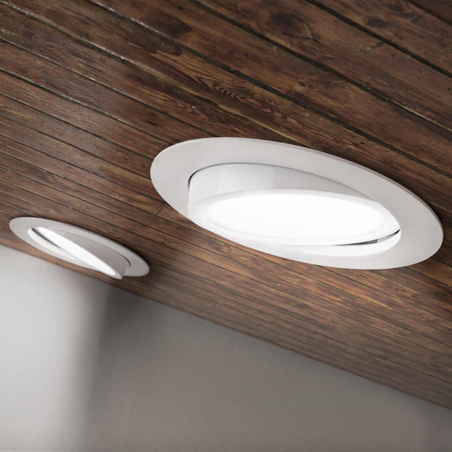 Seen on edge, the IC Rated Slim Gimbal with flexible optic is shown here without the included junction box and cabling. You can clearly note the spring clips that hold this thin profile ceiling light in position. The gimbal is adjustable to aim the light where you need it. Choose color temperature from 5 selections of white light with the slider on the junction box (not pictured here). This 6-inch wide downlight is quickly installed in the ceiling and offers instant on, dimmable downlight.