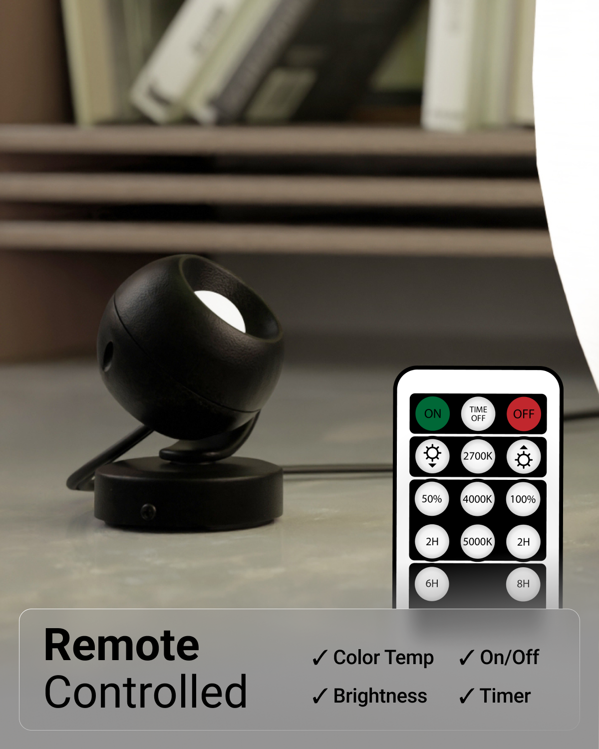 Black spherical lamp with remote control on a surface