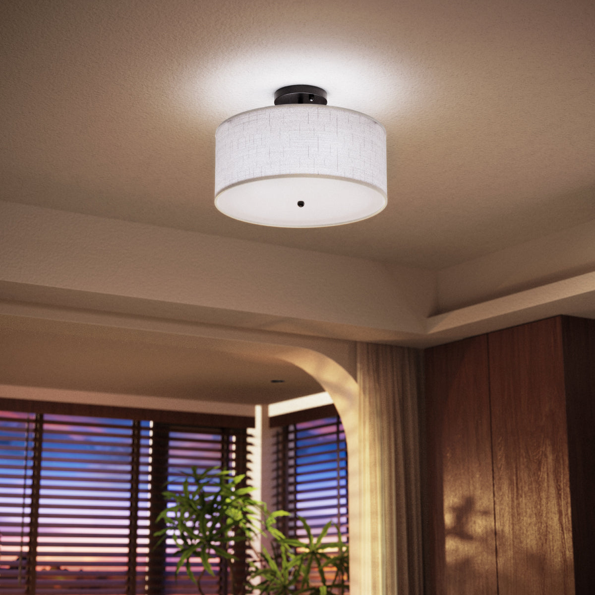  Side view shows linen drum shade, matte black metal base, and white diffuser panel with center finial