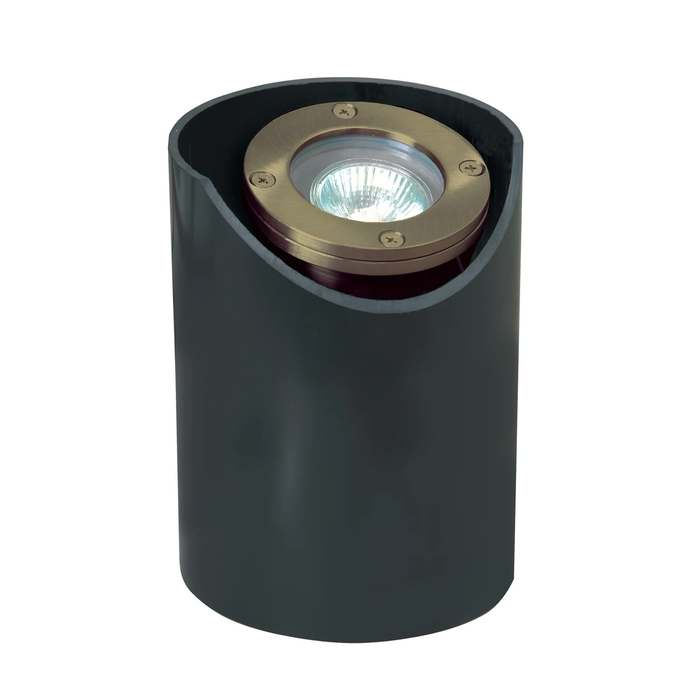 A modern cylindrical outdoor in-ground well light fixture with a matte black body and a circular brass-toned metal top housing a clear light source, shown on a plain white background.