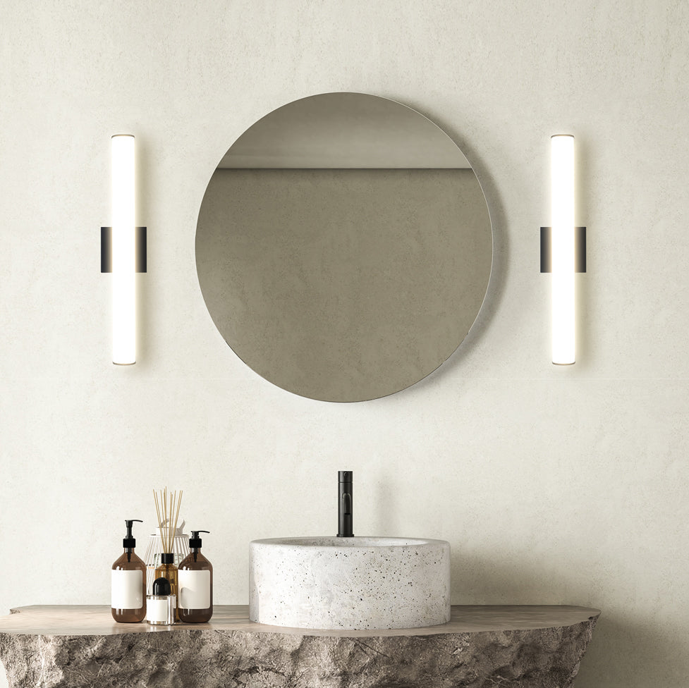 Black linear vanity lights mounted vertically at mirror