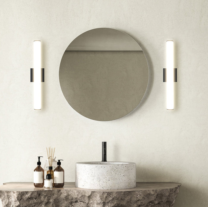 Black linear vanity lights mounted vertically at mirror