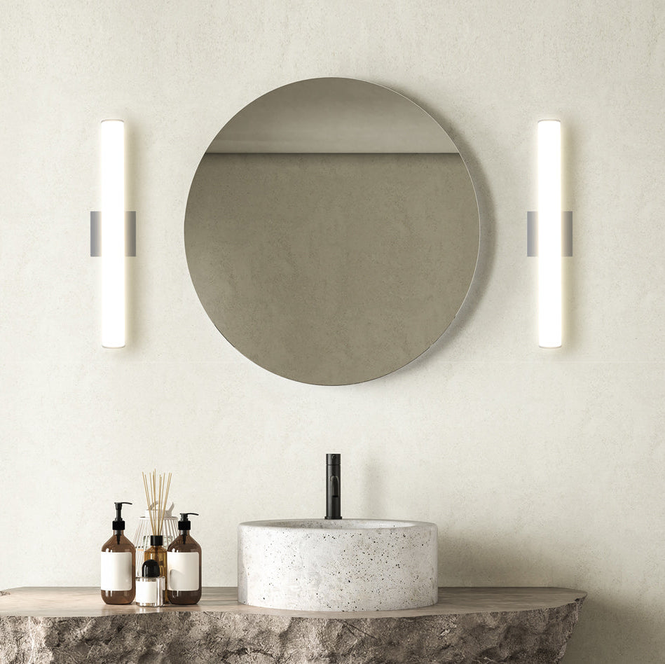 Brushed-nickel linear vanity lights mounted vertically at mirror