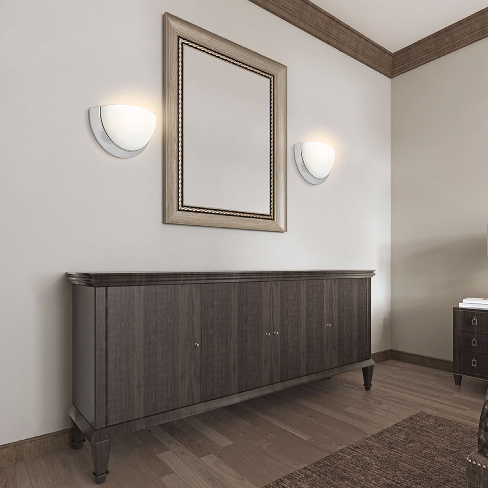 Brushed-nickel bowl wall sconces around bathroom mirror