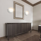 Brushed-nickel bowl wall sconces around bathroom mirror