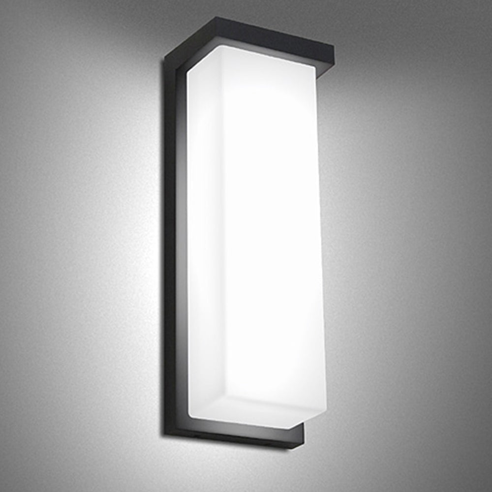 Tall black rectangular wall light installed illuminated
