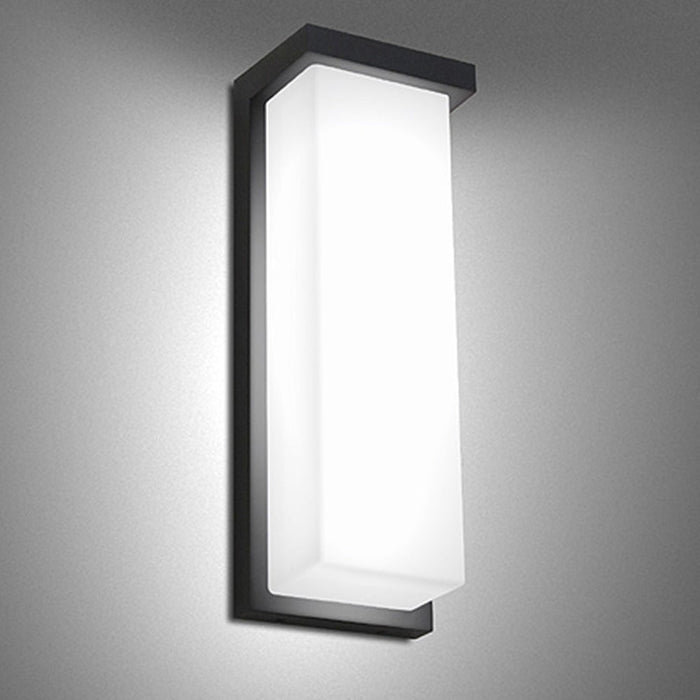 Tall black rectangular wall light installed illuminated