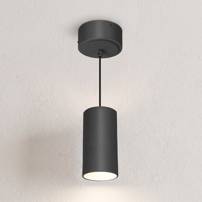 Black cylinder pendant on wall-textured background