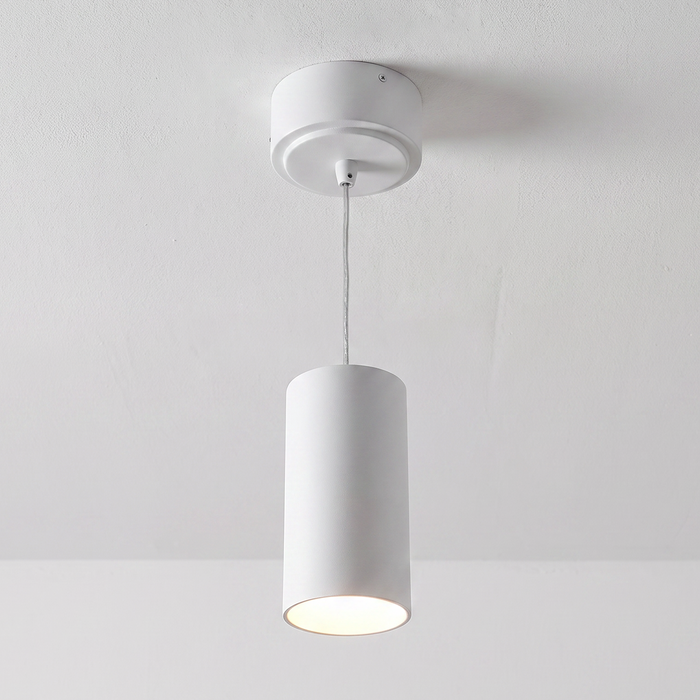 White cylinder pendant installed illuminated