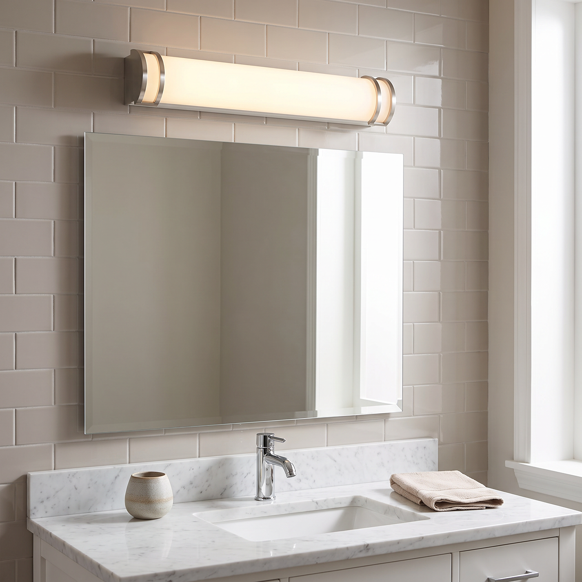 Brushed-nickel short tube vanity light above mirror