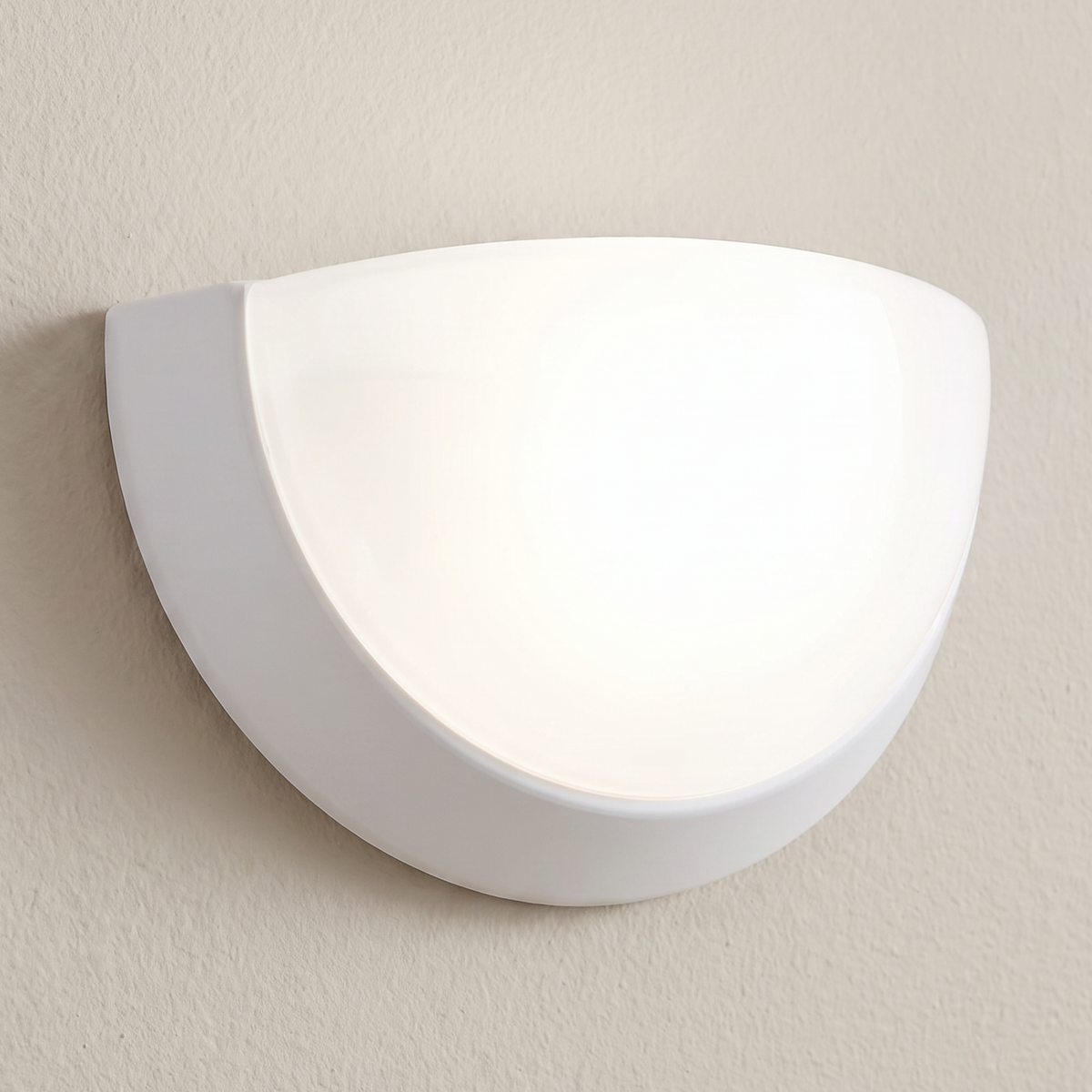 White bowl wall sconce installed illuminated
