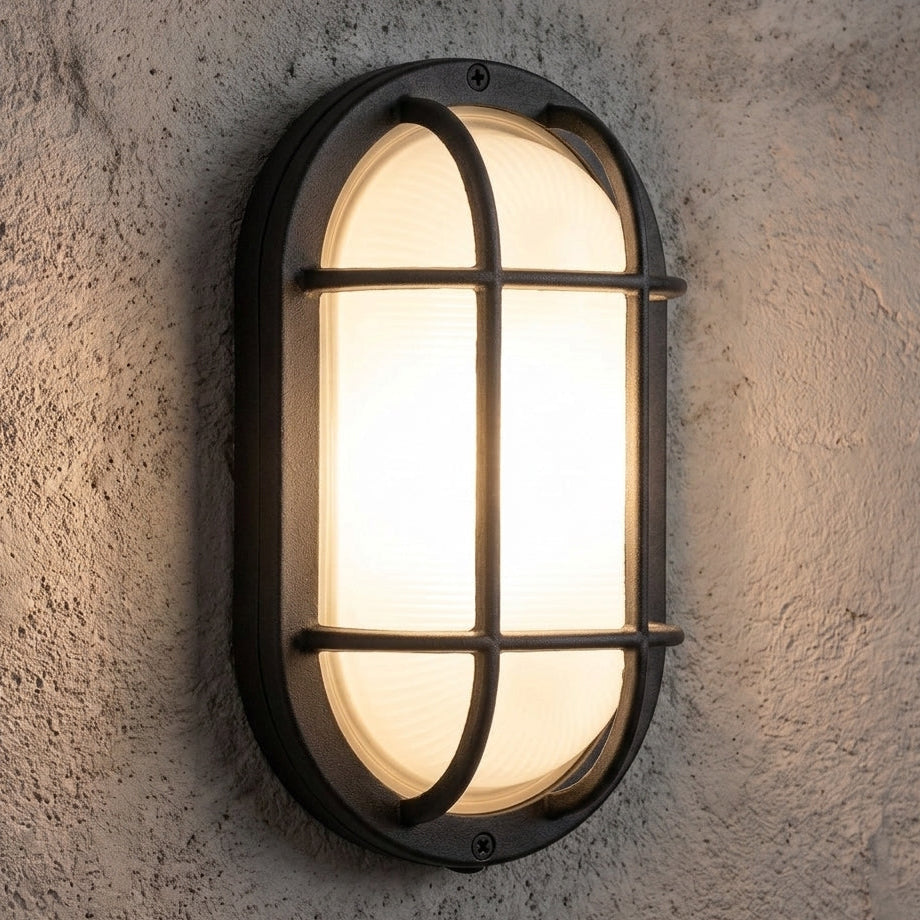 Black oval bulkhead wall light installed illuminated
