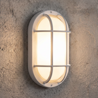 White oval bulkhead wall light installed illuminated