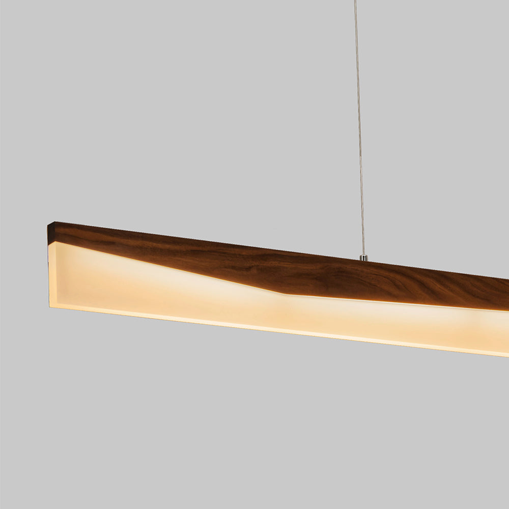 Walnut trough-profile pendant close-up illuminated