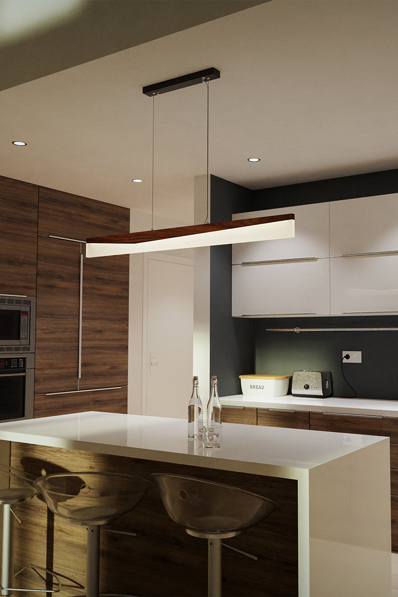 Walnut trough-profile pendant over kitchen island