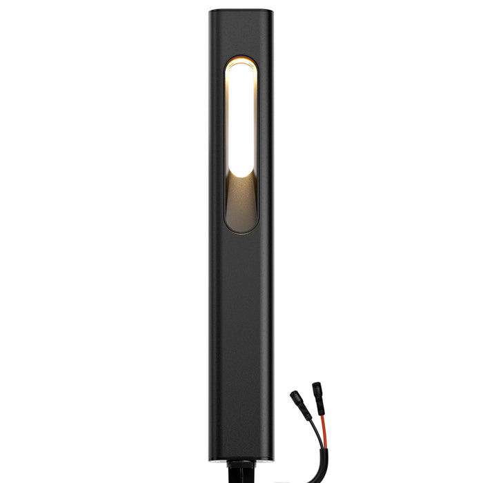 Black rectangular LED path light with a glowing vertical bulb on its front and black and red wires on its bottom