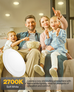 Family movie night under warm recessed-style disk lights; “2700K Soft White” callout for a cozy, inviting glow.