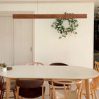 Walnut long linear pendant over dining table