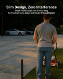 Man mowing grass without obstruction from slim LED path lights along the lawn border