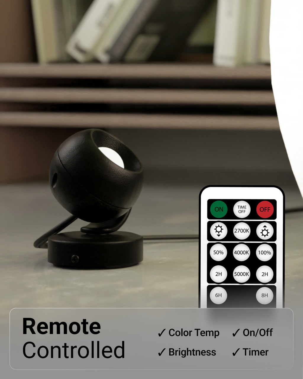 Black spherical lamp with remote control on a surface
