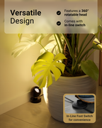 Light fixture with plant on a surface, highlighting features like 360-degree rotation and in-line switch.