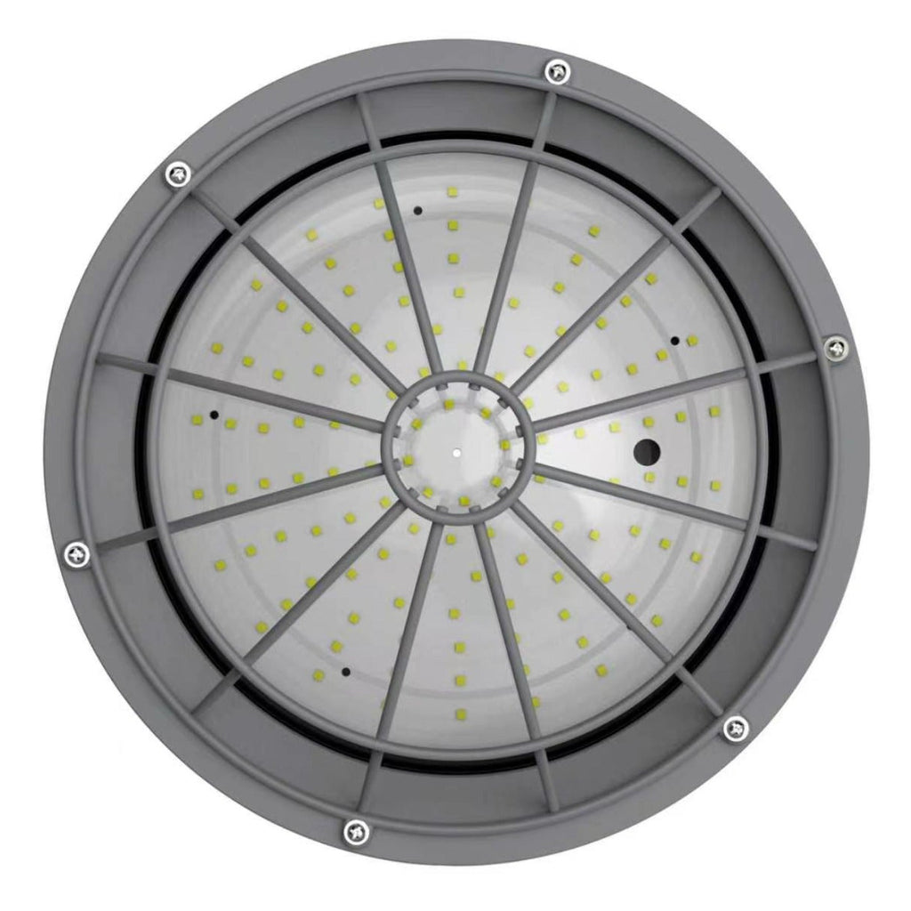 A circular industrial LED light fixture with a gray metal frame, radial internal ribs, and a clear diffuser panel showing many small yellow-green LED chips, photographed on a white background.