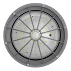 A circular industrial LED light fixture with a gray metal frame, radial internal ribs, and a clear diffuser panel showing many small yellow-green LED chips, photographed on a white background.