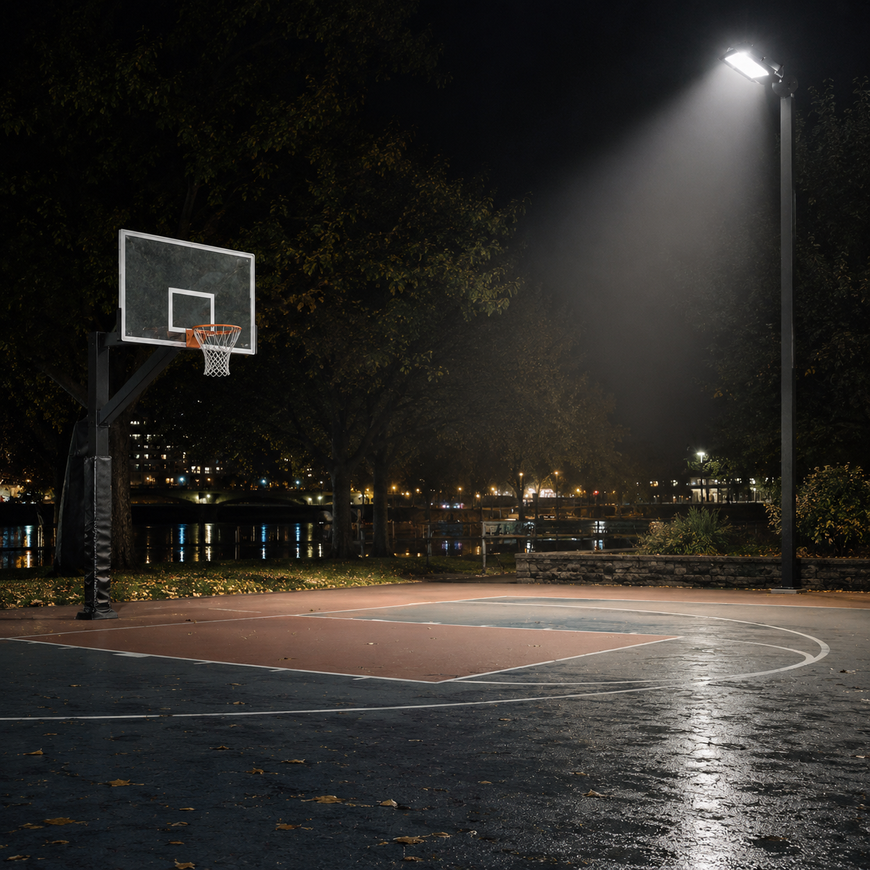 Basketball court at night with LED flood light slip fitter mount illuminating the area