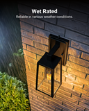 Wet Rated. Sunco’s Avalon Caged Wall Sconce with Dusk to Dawn technology is water and weatherproof. It is suitable for open areas like porches, walkways, hallways, entryways, and walls both inside and out. Image features the Avalon Caged Wall Sconce with ST64 LED Filament Bulb on the exterior of a home with rain falling. You can clearly see the LED filament bulb inside the black, durable frame.