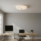 Modern home office with a desk, chair, computer monitor, and laptop under a ceiling light.