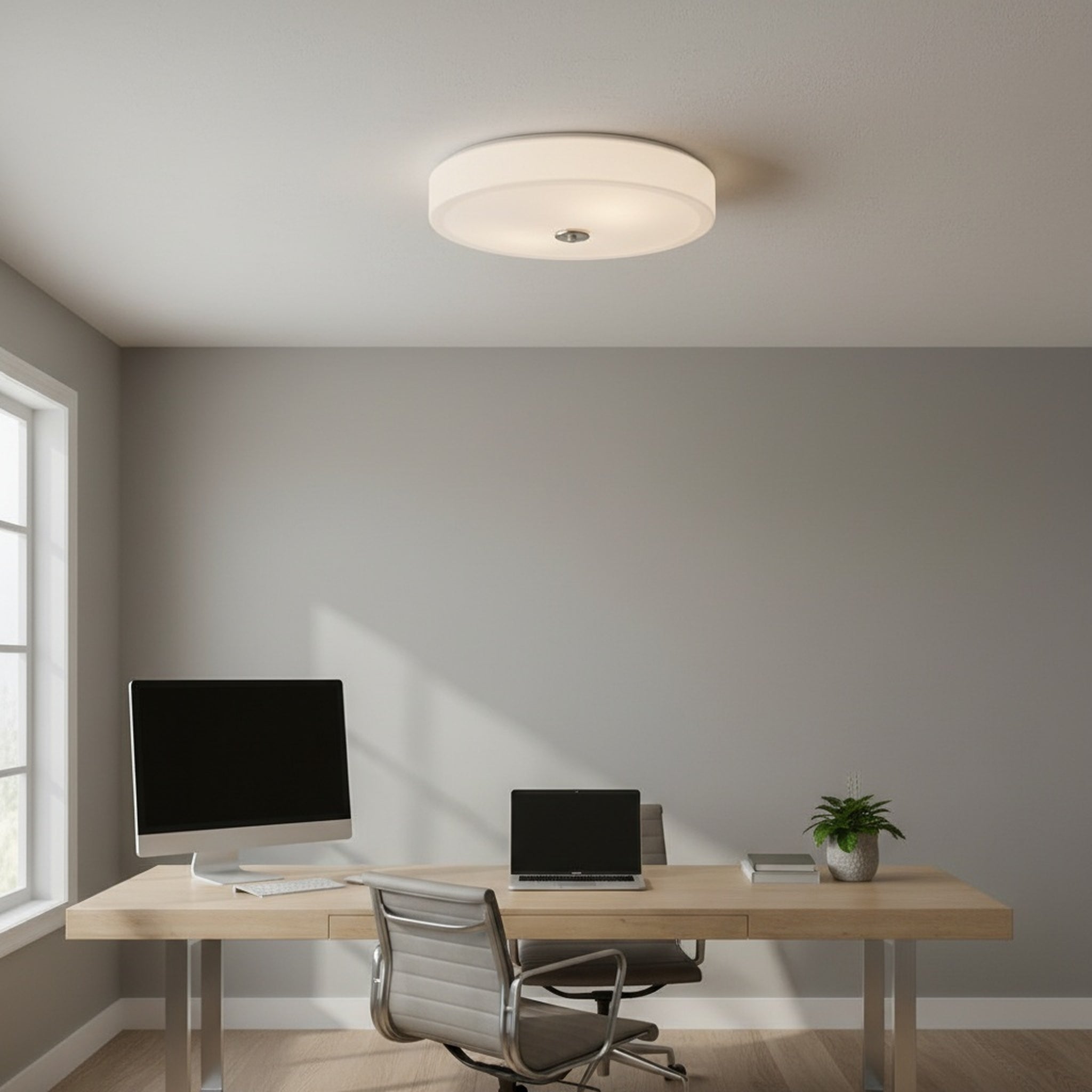 Modern home office with a desk, chair, computer monitor, and laptop under a ceiling light.