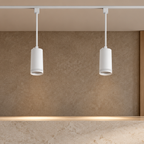 White LED track pendants installed on ceiling track in an interior space